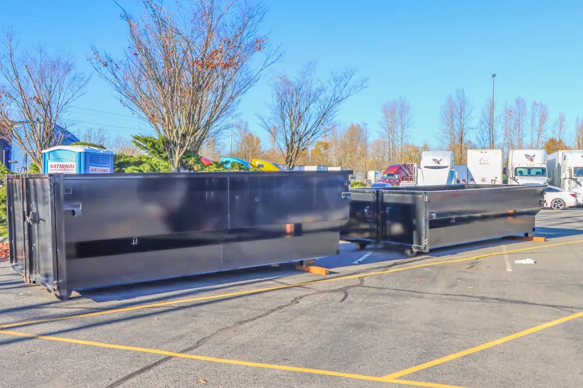 Professional dumpster rental service with roll-off container on residential driveway in Safety Harbor